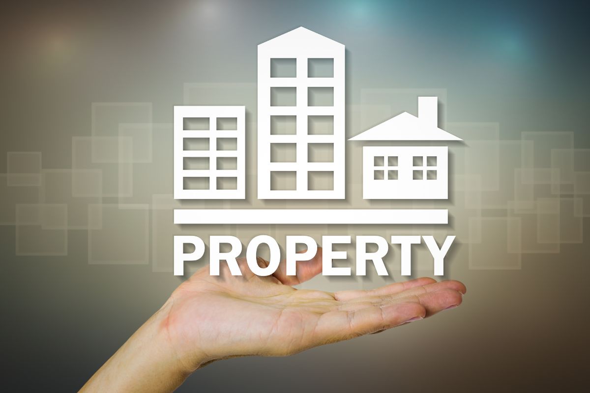 Photo of a woman's hand showing a property concept.