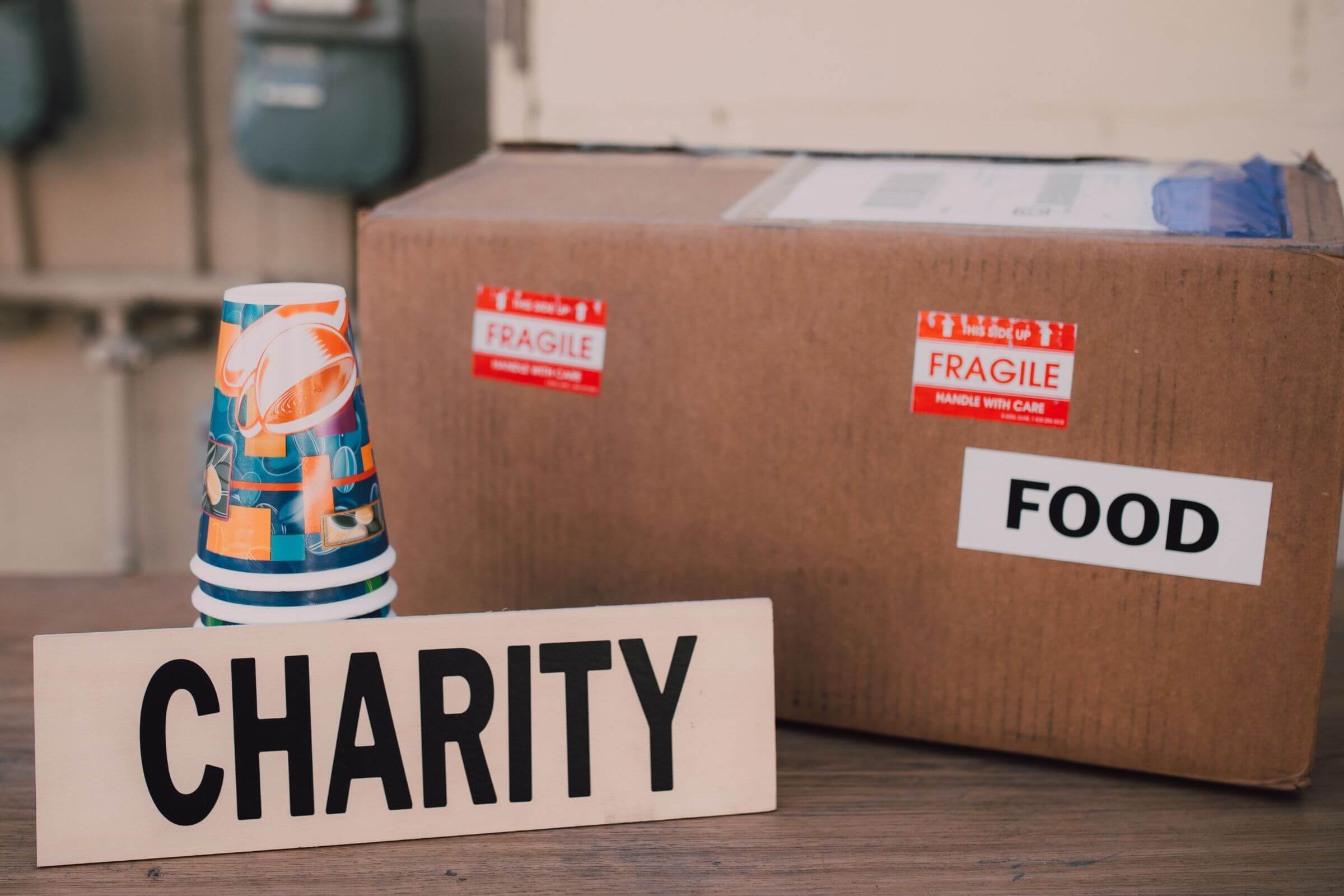 The picture of cups, a box with a note, and a piece of paper with a note refer to a plan for charitable donations ensuring that your legacy will live on as you intended.