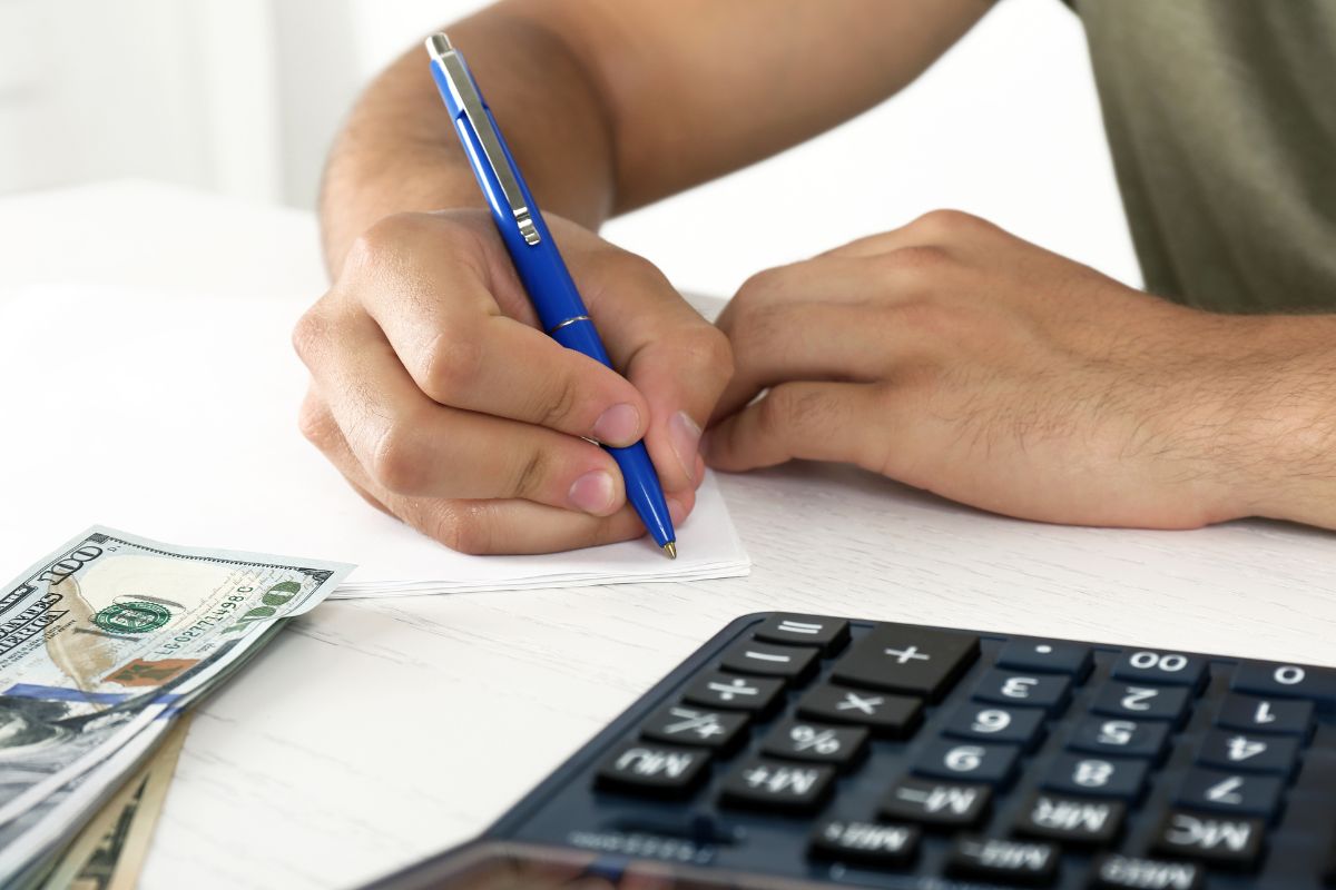 Image of a man's hand budgeting.