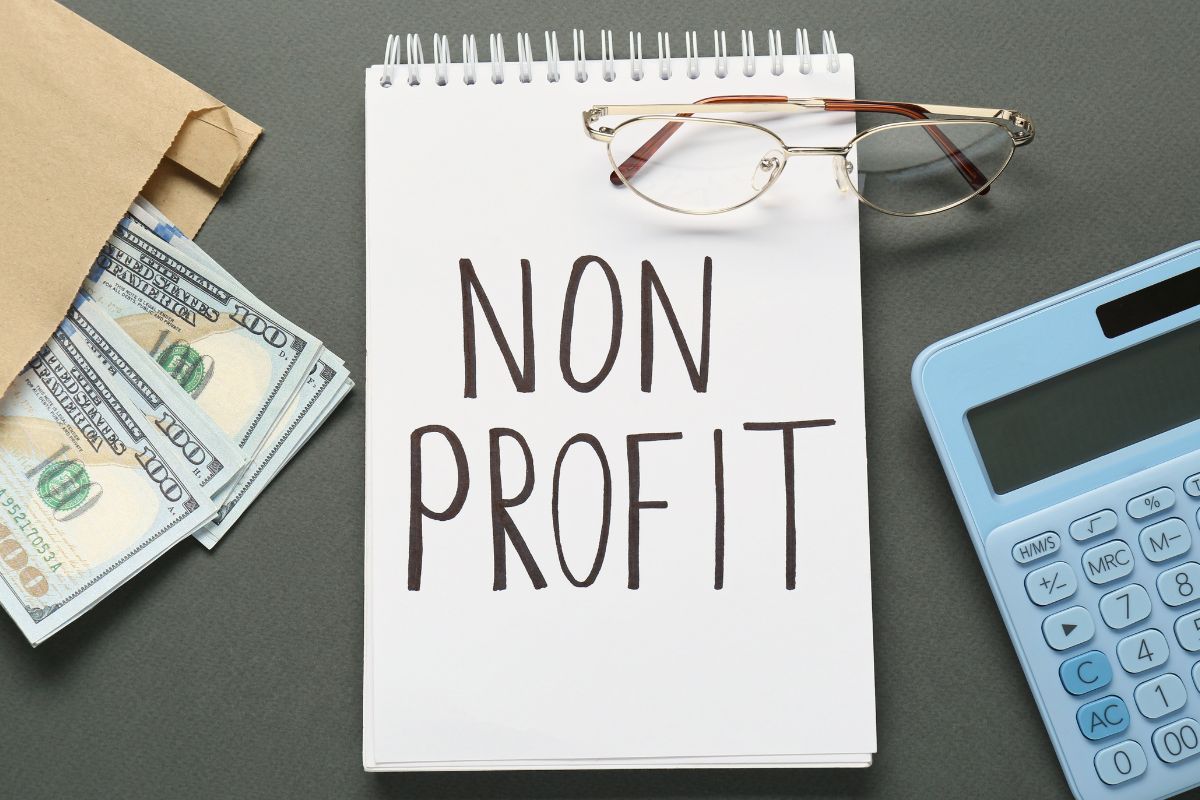 Photo of money and a notebook with nonprofit written.