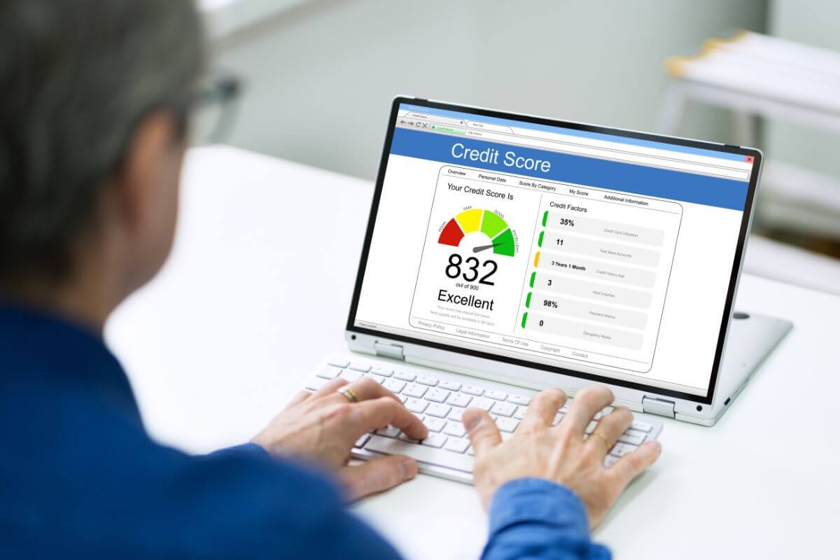 The picture tells about a man using a laptop with a screen display which means monitoring your credit score regularly to track progress helps you stay informed about what's working and what needs improvement.