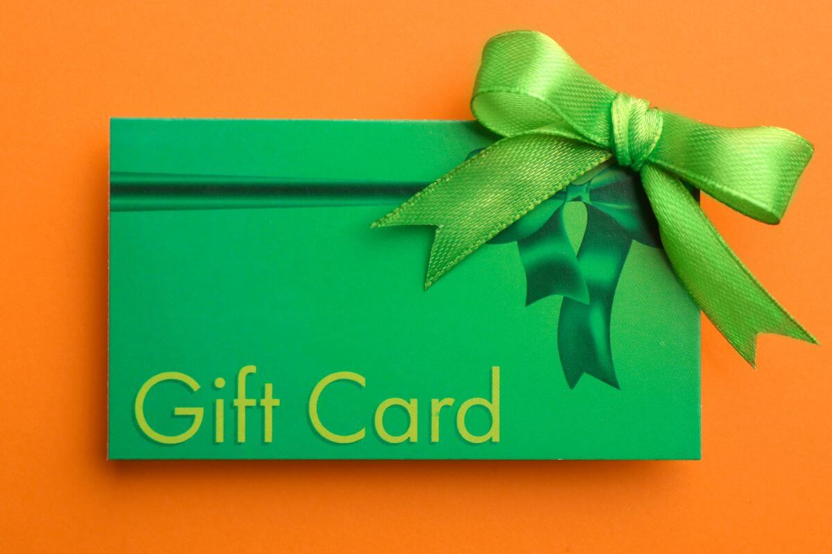 The image tells about a green card with notes and a green ribbon indicating to sell gift cards for cash or trade for essentials to make your budget work harder during tight times.
