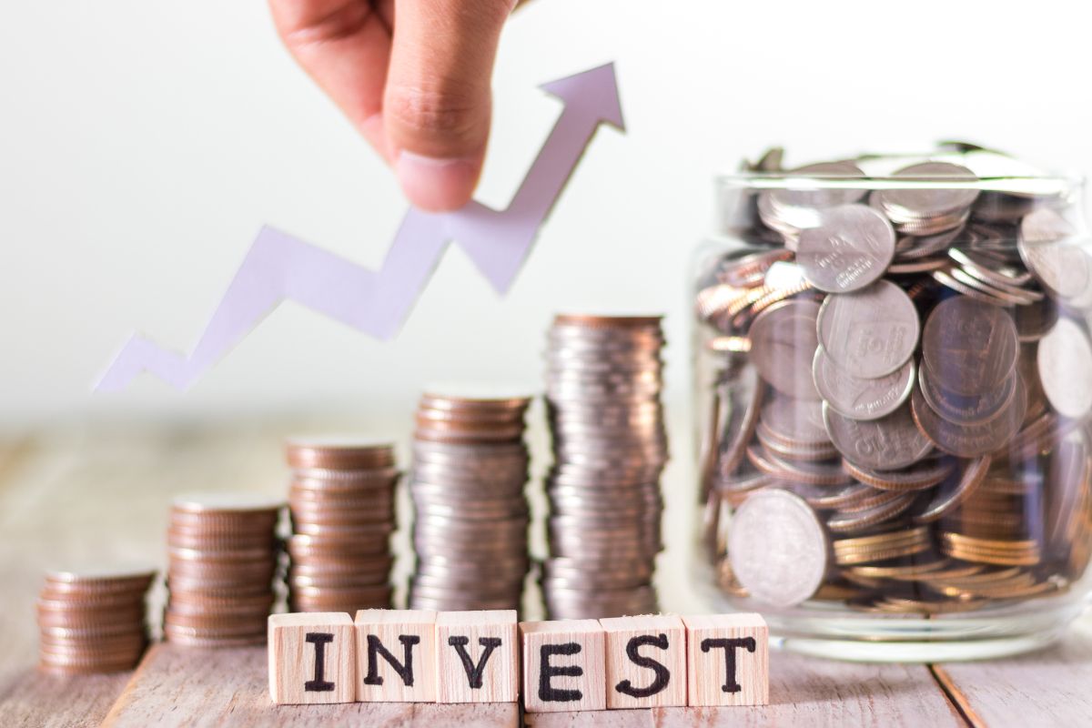 Image of coins and invest wording.