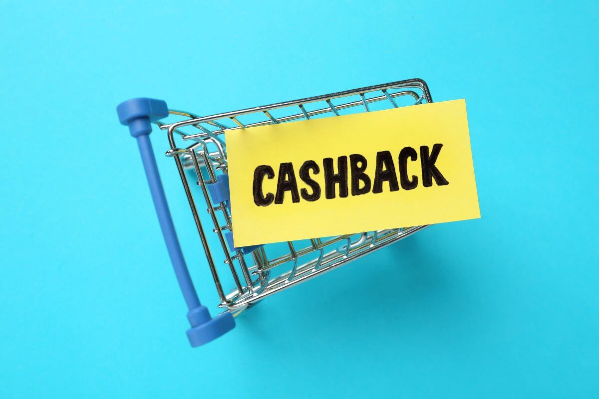 The picture of a mini cart with a piece of paper with a note at the top of it refers to leveraging cashback apps and rewards to provide extra value when money feels tight.