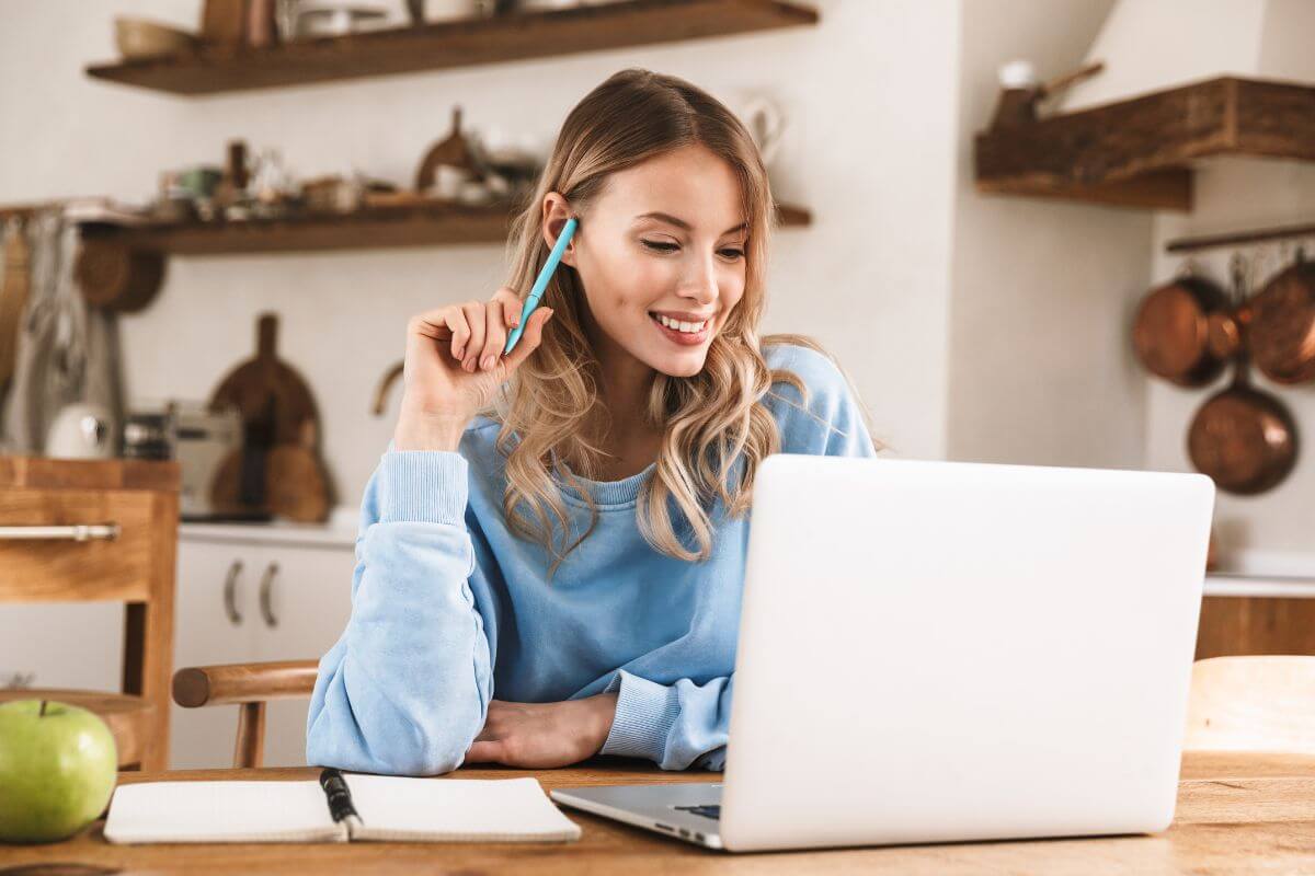 The photo of a notebook and a girl looking at the laptop with her pen to take down notes refers to hone these high-income skills can provide stable income even during tough times.