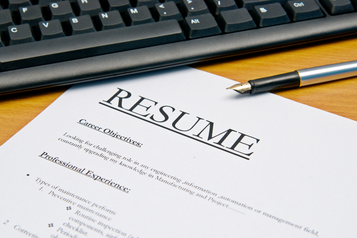 Photo of a keyboard and a resume paper.