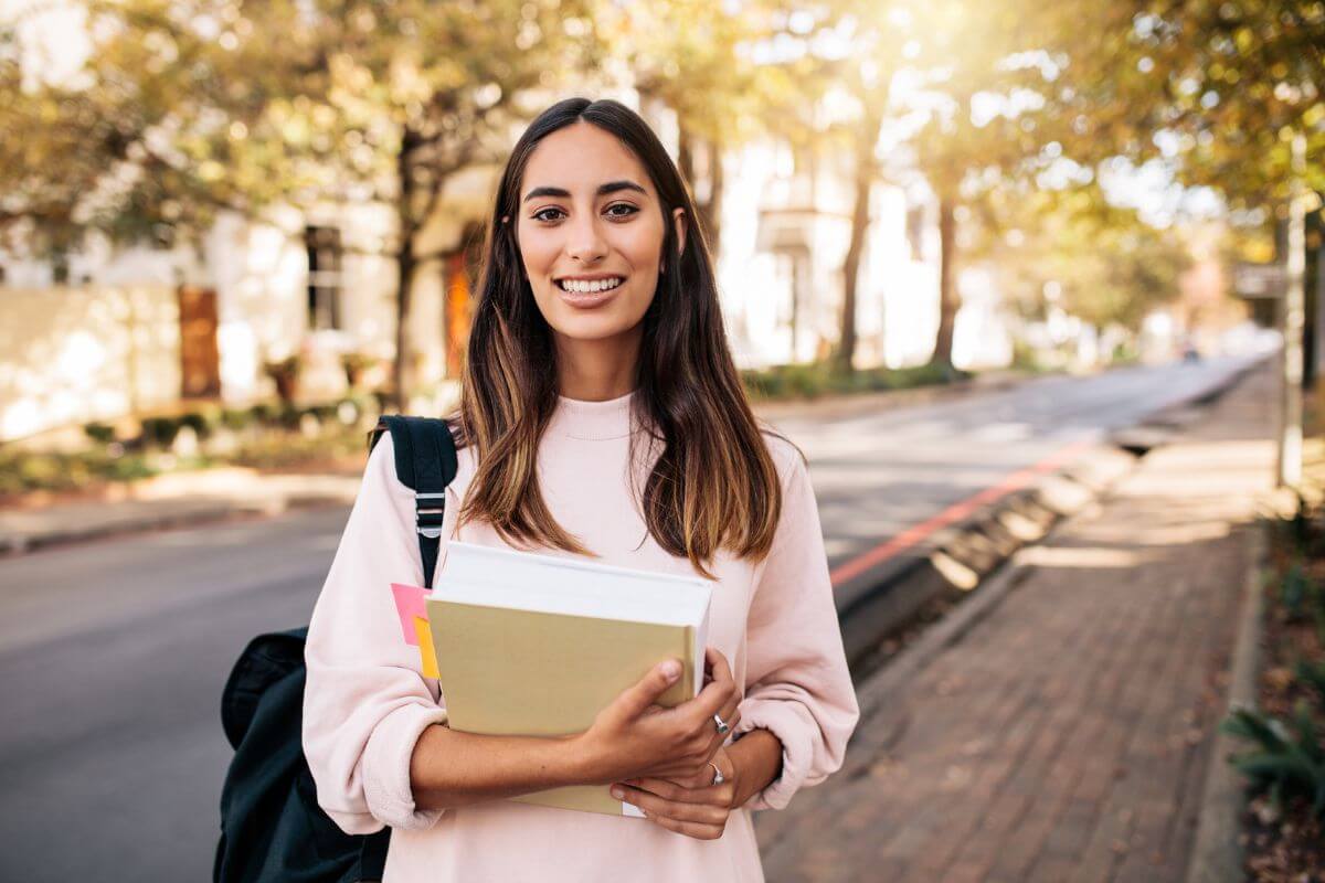 The photo shows a girl carrying a book and a backpack which means to determine if further continuing education is worth it and can lead to better opportunities in the future.