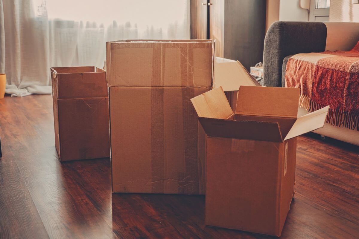 The photo tells about a couch and boxes which means subletting your space and moving to a more affordable temporary location can help your rent while you move somewhere less expensive.