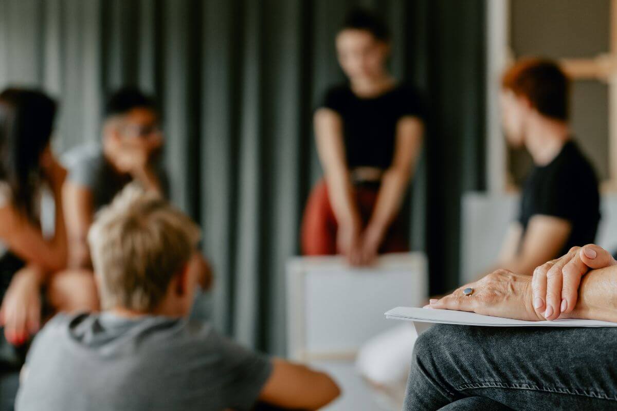 The photo of a group of people talking together which means using your network to find informal housing arrangements can help you save money and stay flexible.