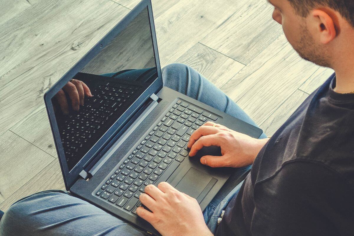 The picture tells about a man using a laptop to brainstorm ways to increase income immediately can help you earn money fast to cover housing payments.