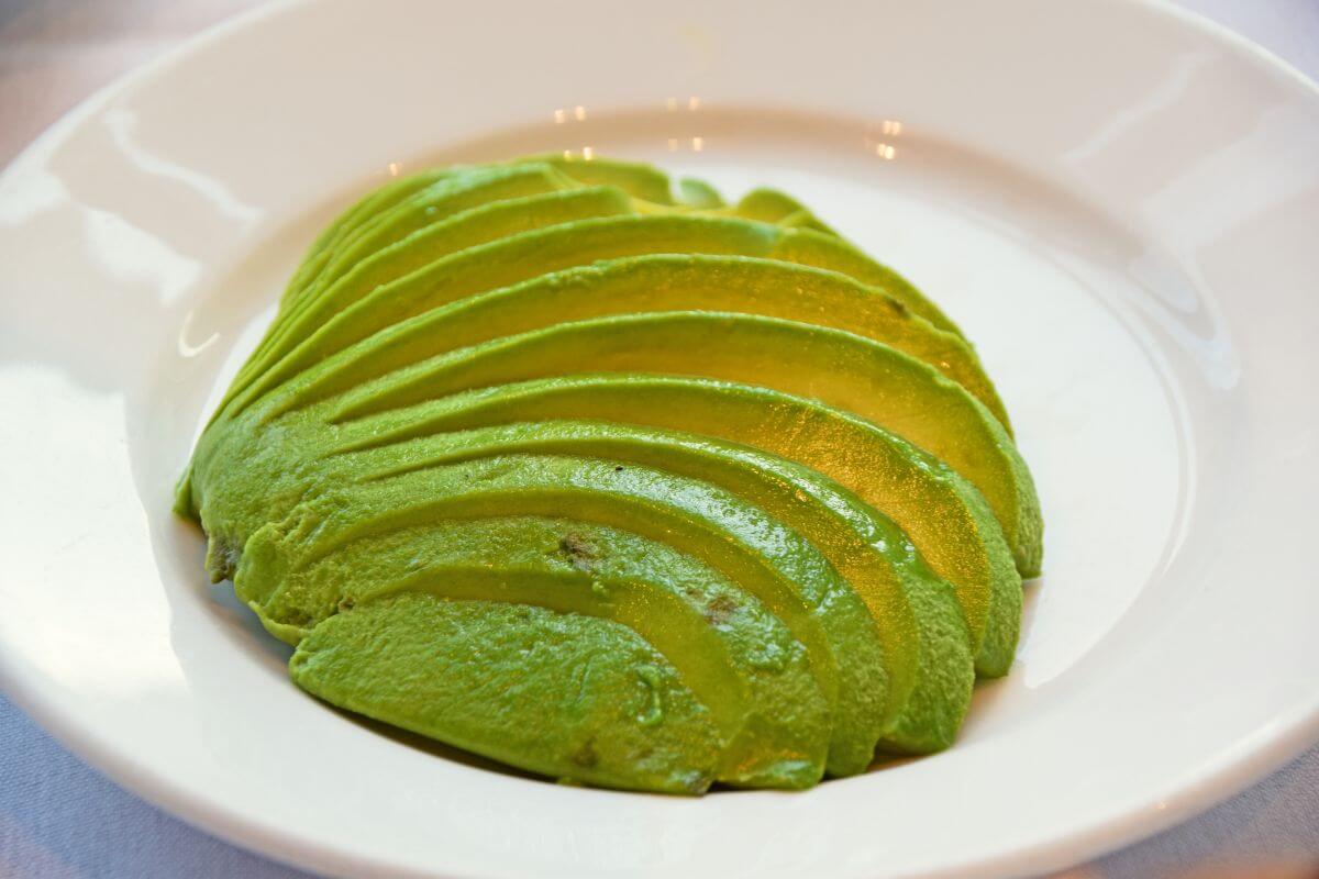 The photo shows a sliced avocado on a plate referring to trendy gadgets like avocado slicers which are unnecessary, and focus on items that are versatile and worth it.