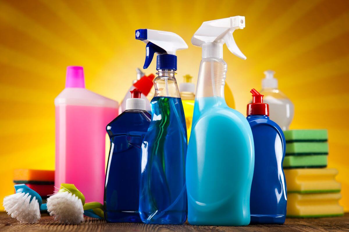 The image of brushes, bottles with liquids, and sponges referring to the name-brand cleaning products can add up costs, and save money by switching to store brands.