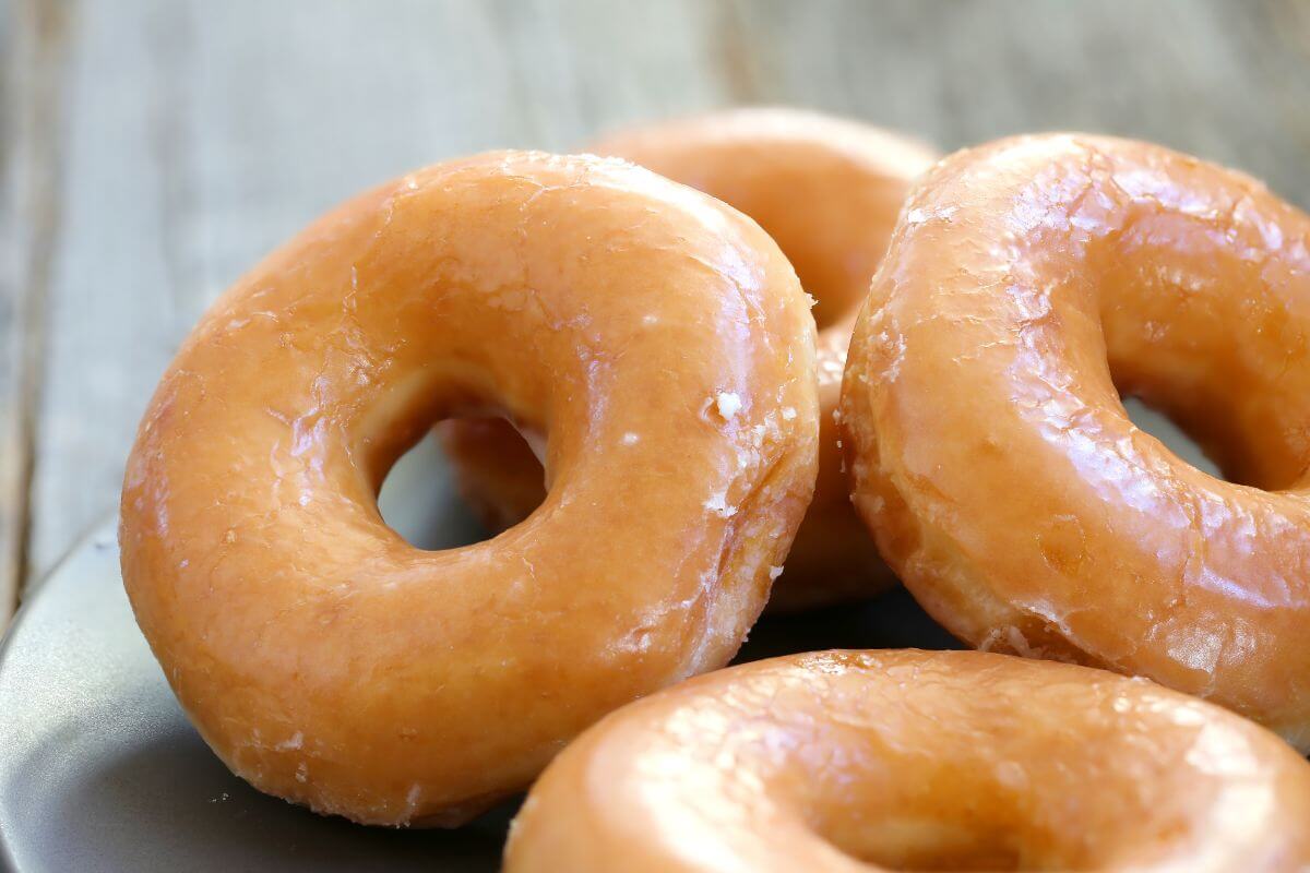 The picture shows glazed donuts on the plate referring to obscure kitchen appliances that can add up cash, cutting these purchases keeps your kitchen and budget uncluttered.
