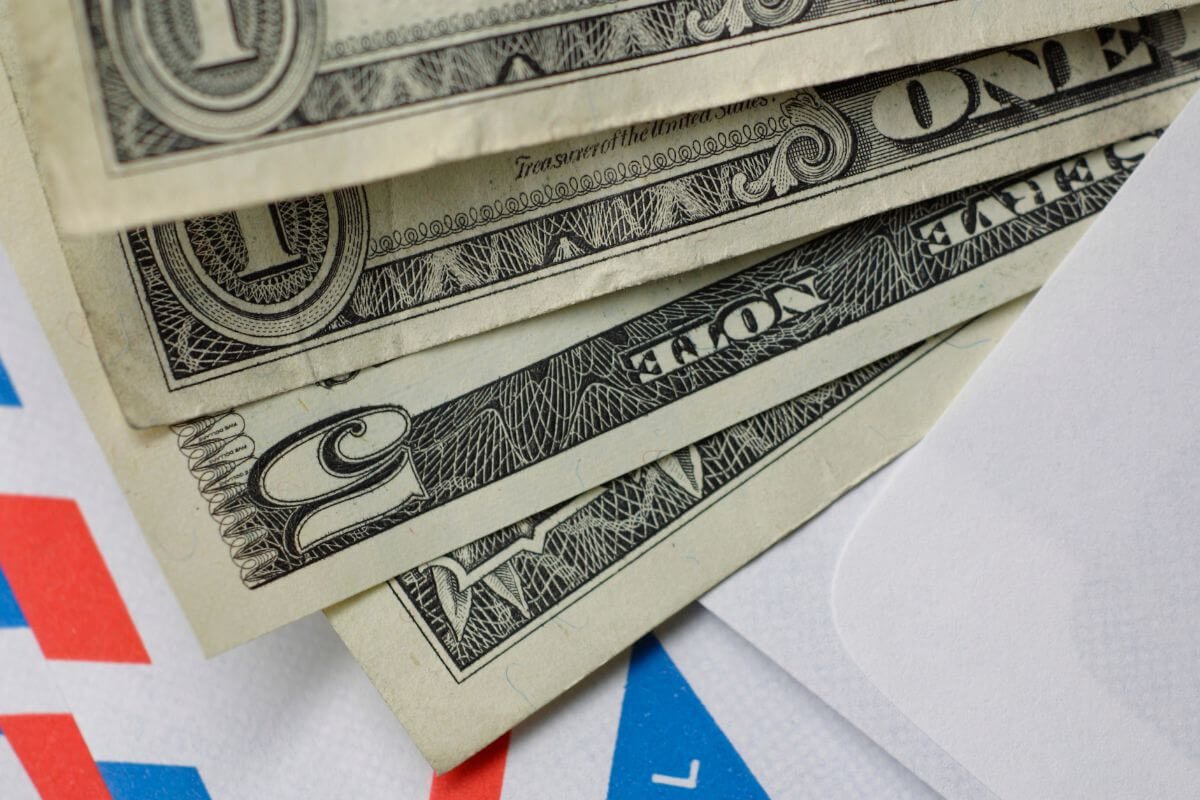 The picture shows envelopes with dollar bills which means learning to budget using cash in envelopes helps teens stay organized and avoid overspending.