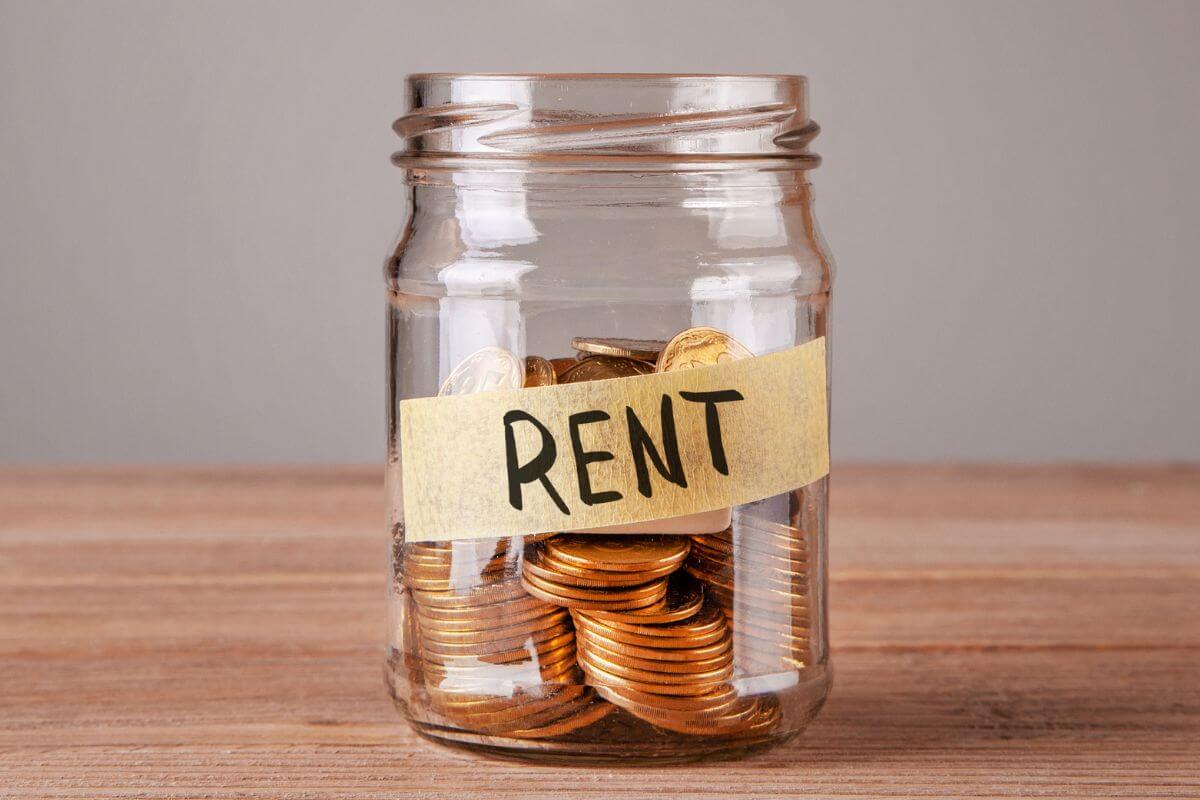 The photo tells about a jar filled with coins and a note indicating to pay rent to parents for practice which is a creative way to teach budgeting while building up their savings.