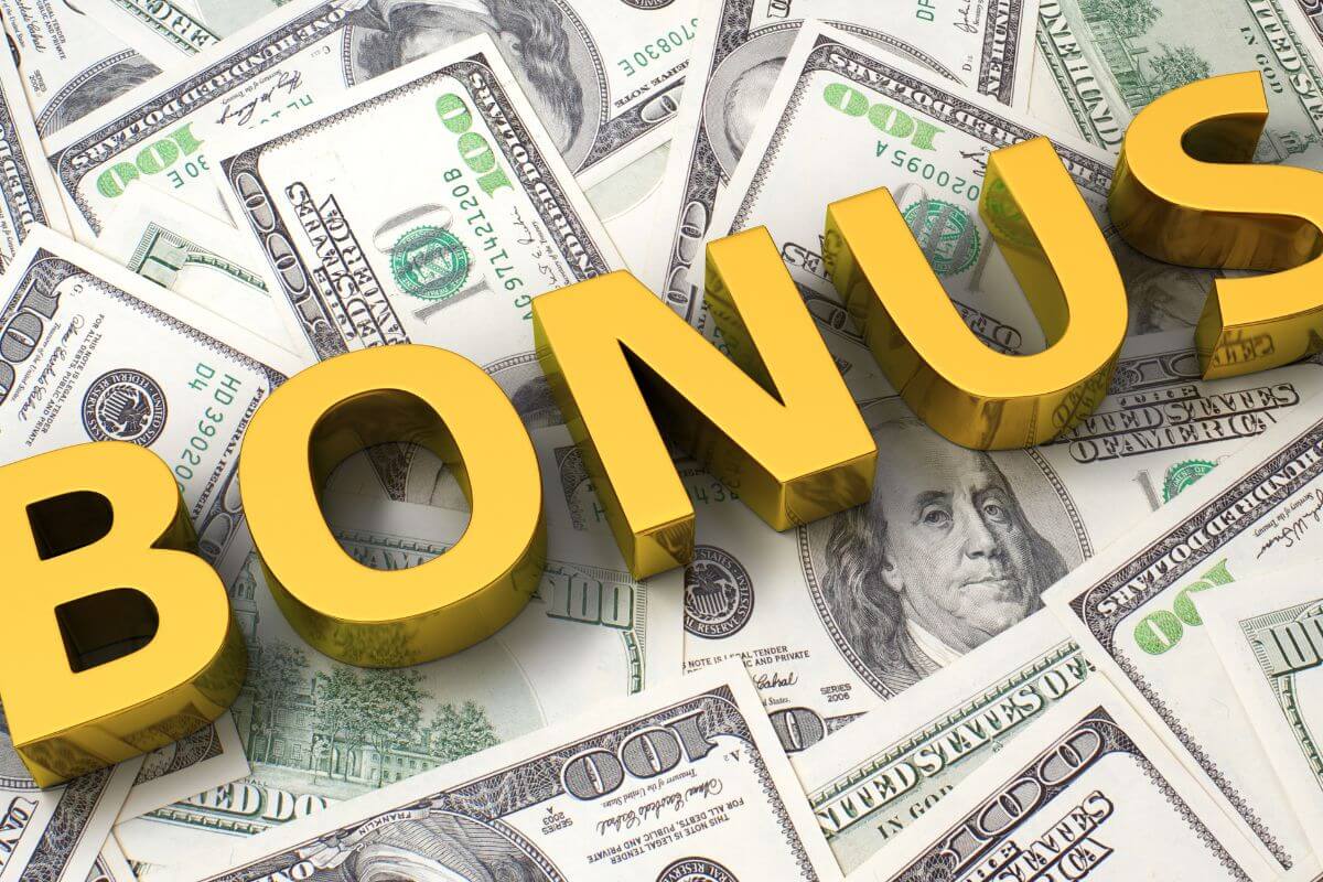 The image tells about dollar bills and letters indicating to turn every windfall into investments to achieve financial freedom faster.