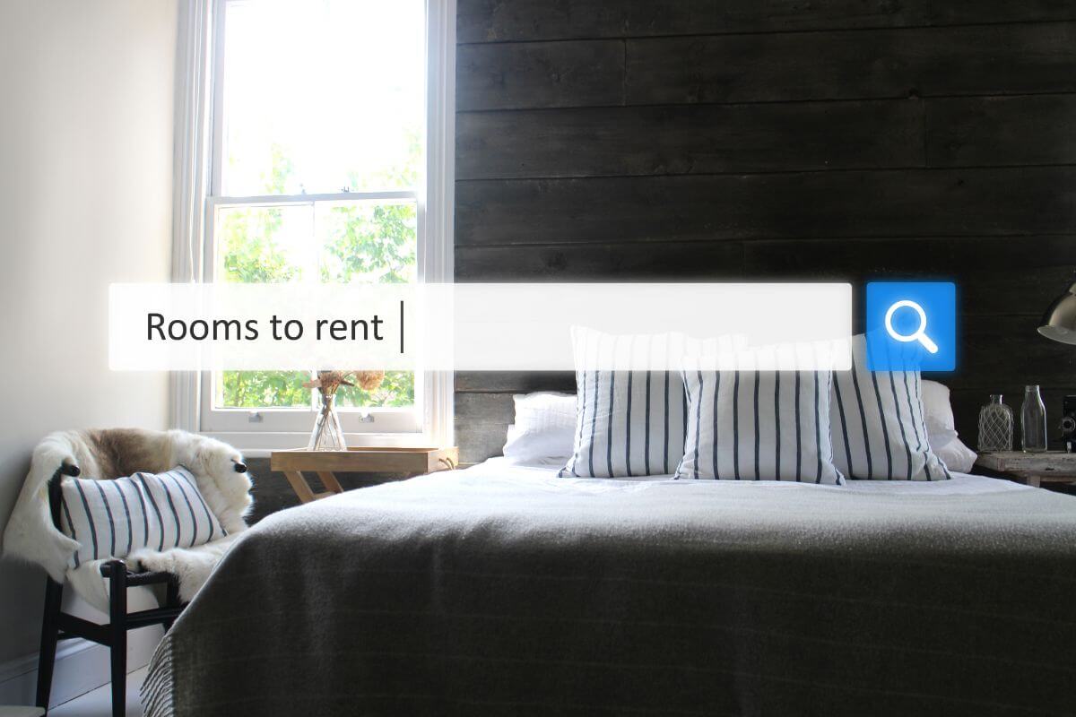 The image shows a bed, pillows, a chair, and a table which means that downgrading your living situation can free up a lot of cash.