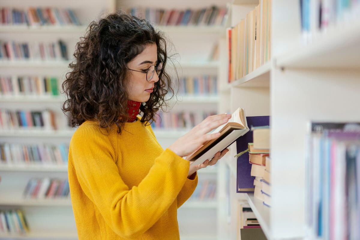 The image tells about a girl reading a book which means referring to commit to a library life by borrowing books to enjoy entertainment and learn new things can save you hundreds every year.
