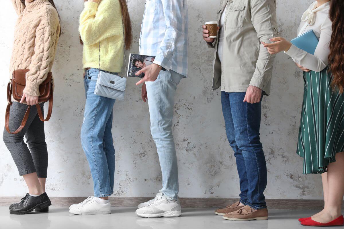 The image tells about a group of people queuing together referring to professional line sitters for exclusive events for others is straightforward and surprisingly lucrative for high-demand events.