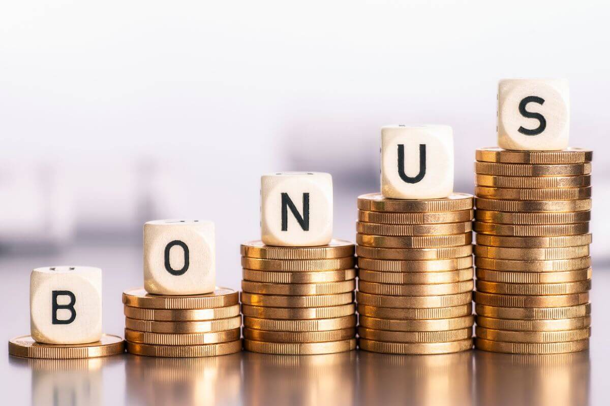 The image shows coin stocks with cubes and letters indicating to turn every unexpected income into immediate savings and build savings faster without needing to cut into your regular budget.