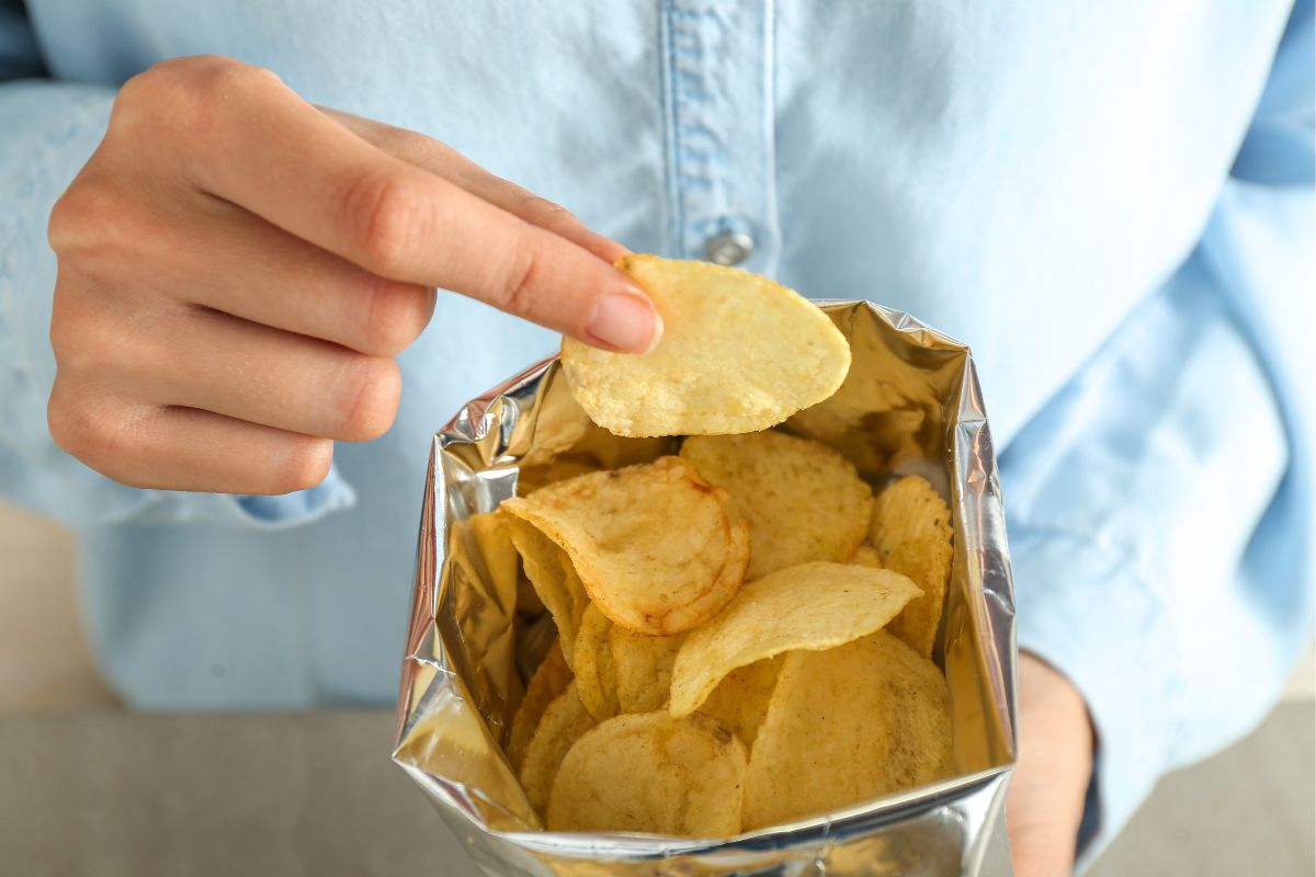 Photo of a woman eating a snack.