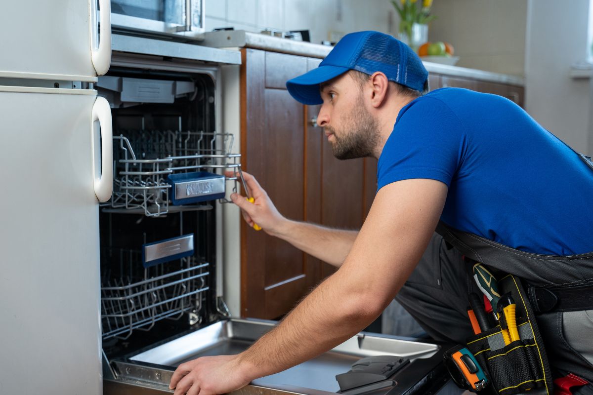 Picture of a man repairing a machine.