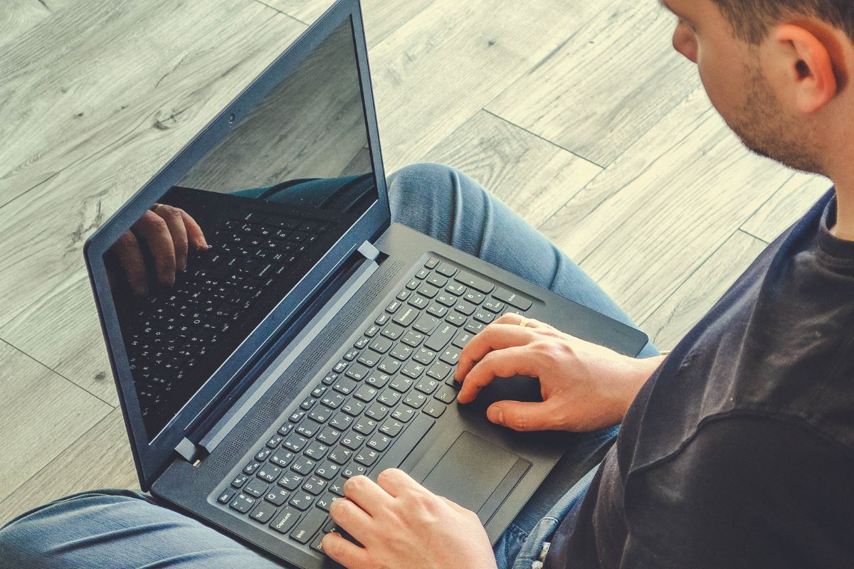 Picture of a man using a laptop.