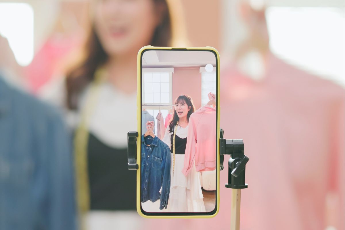 Picture of a woman selling clothes online.