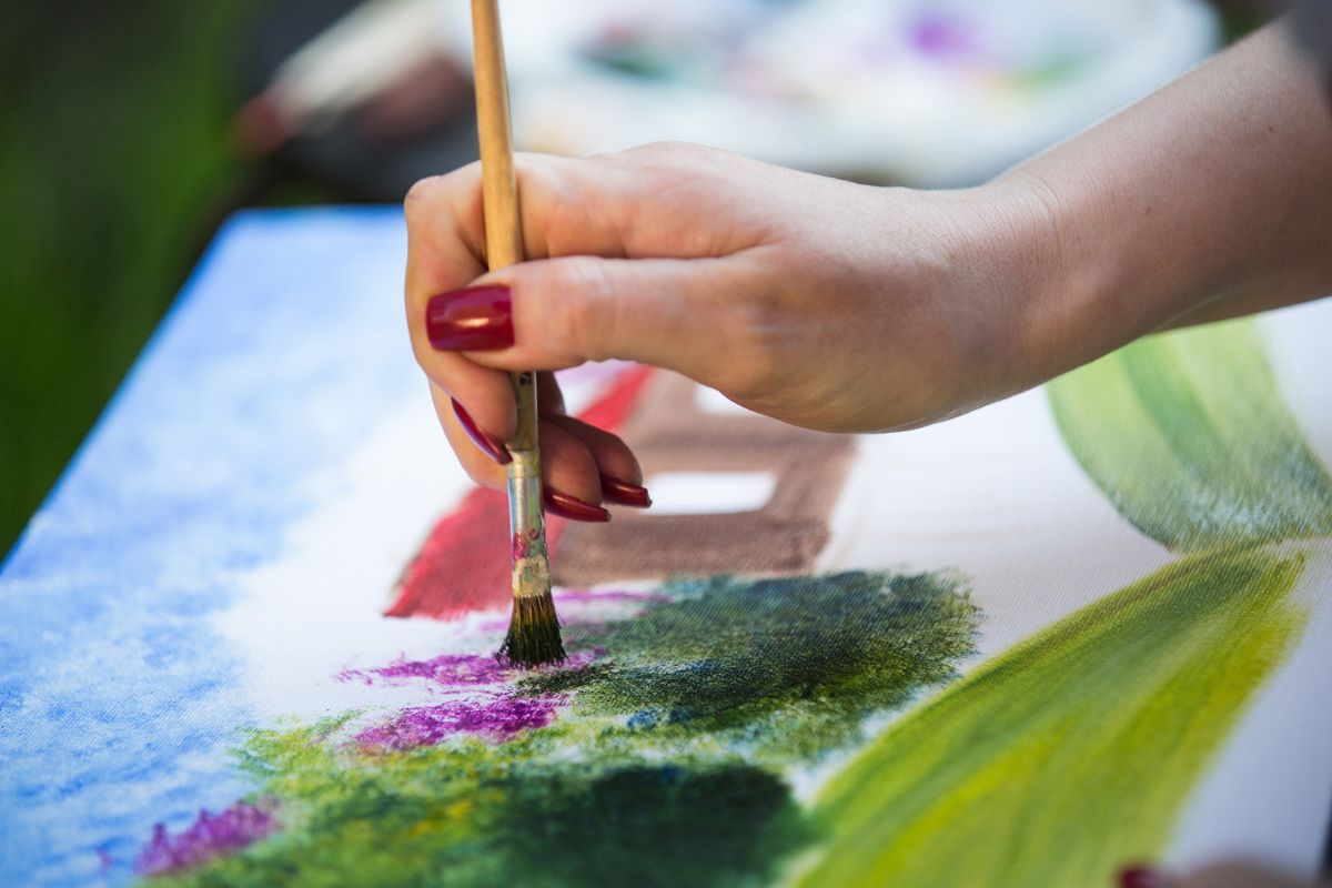 Photo of a woman's hand painting.