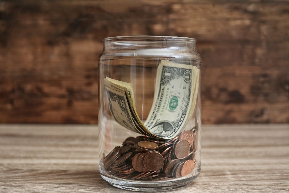 The picture shows a jar with money.
