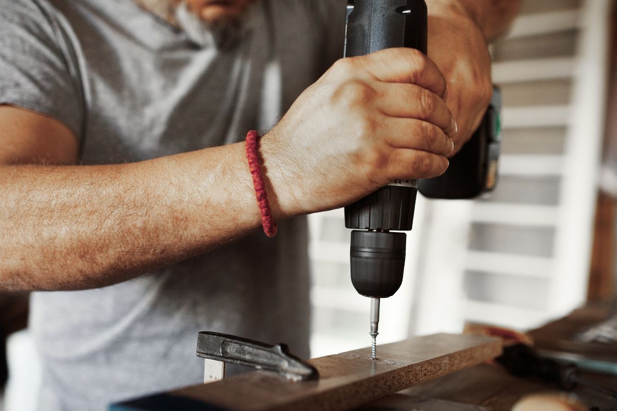 Photo of a man repairing.