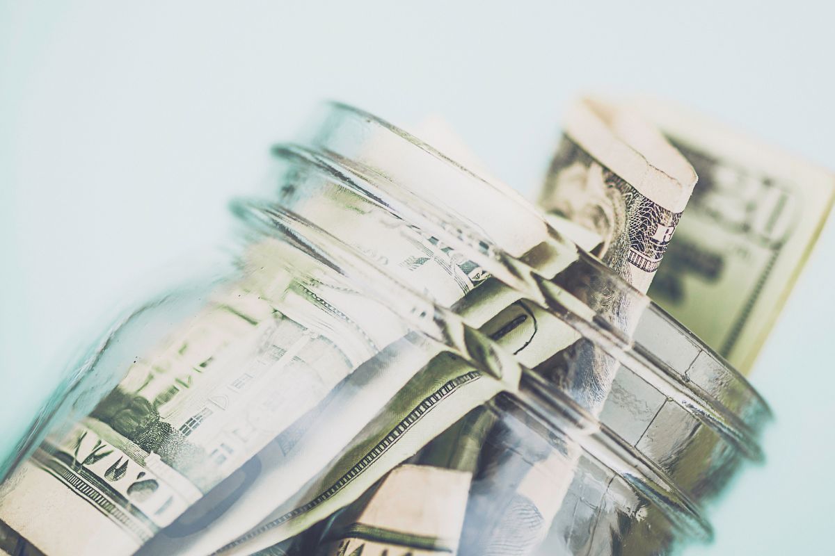 The photo shows a jar with money.