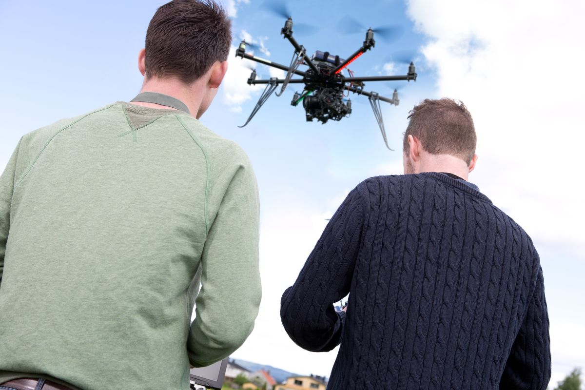 Picture of men operating a drone.