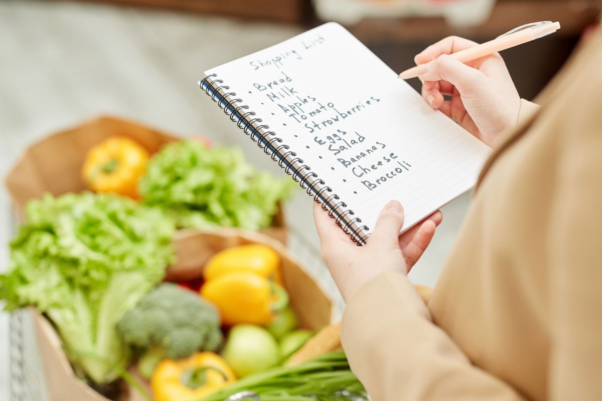 The image shows a woman checking her grocery list.