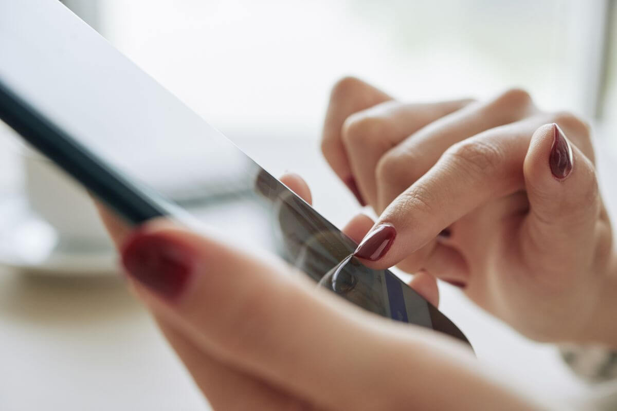 The photo tells about a girl's hand using a phone which means that using apps or tools to gamify savings can help you stay committed to your goals.