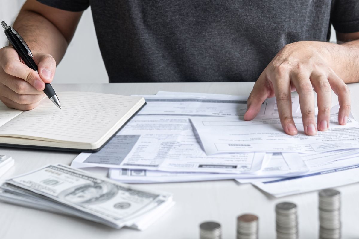The image shows a man cutting expenses.