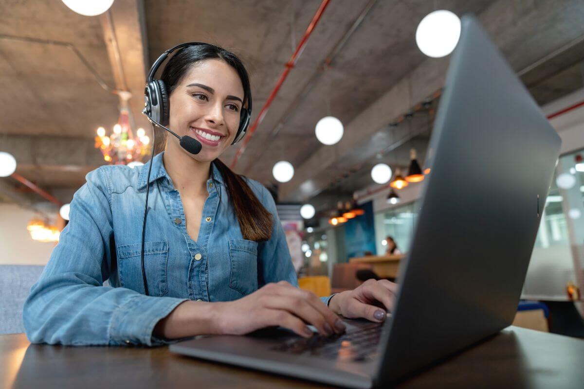 The photo tells about a girl using a laptop with her headset which means taking on a temporary side hustle can bring in extra money to pay down debt or save faster.