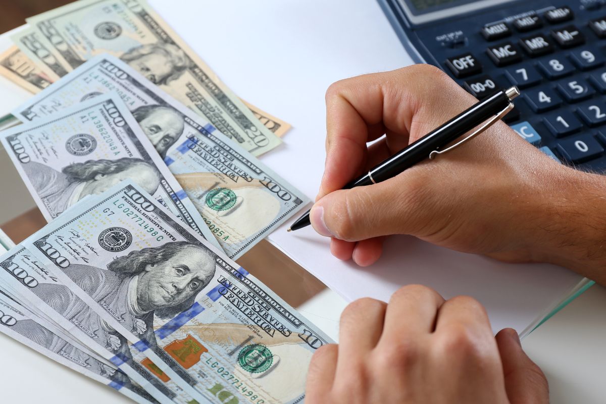 The photo shows a man budgeting.