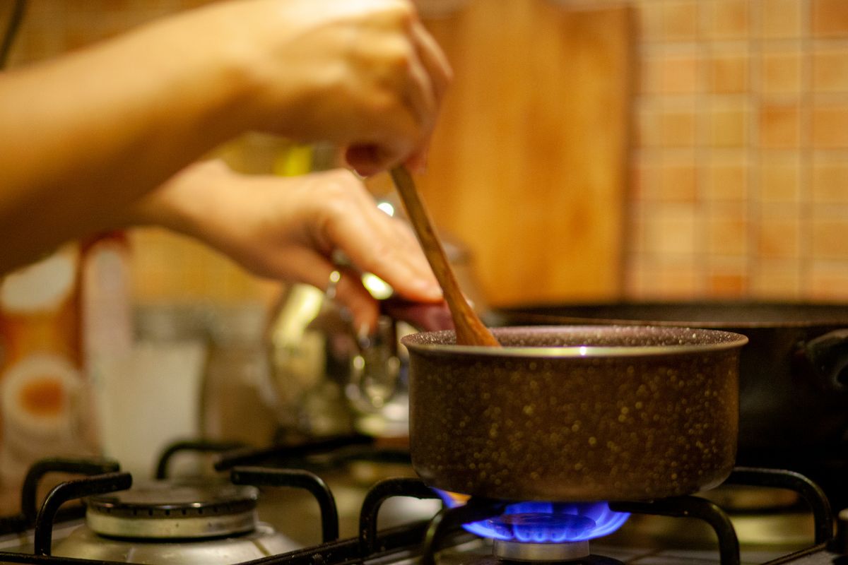Photo of a woman cooking a meal at home.