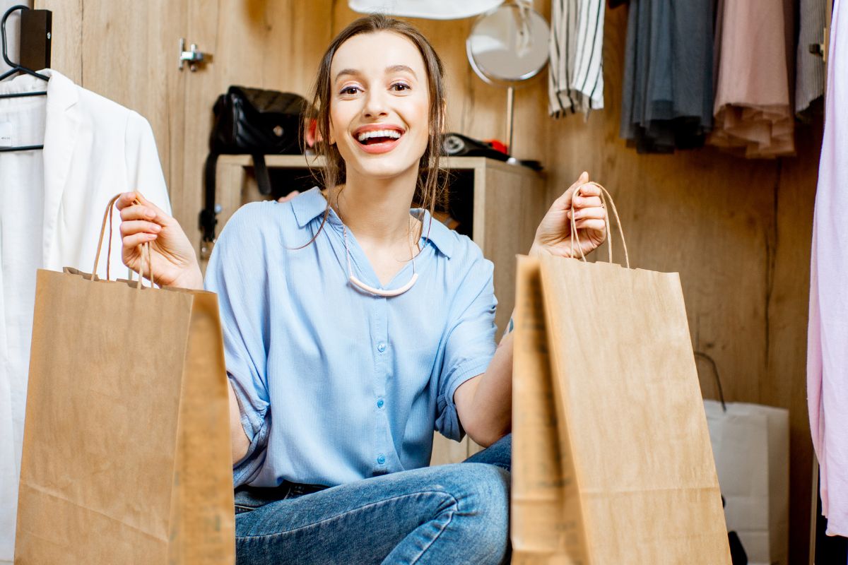 The picture shows a woman purchasing in a thrift store.