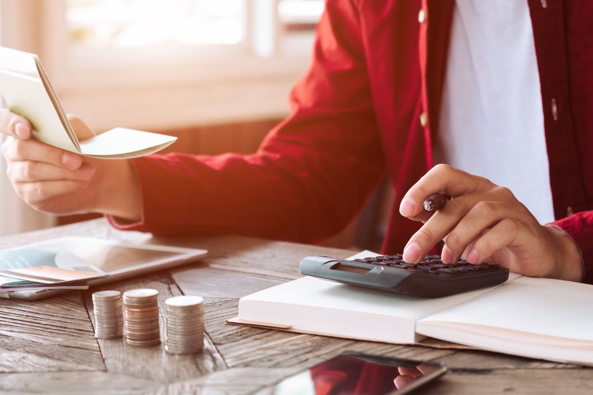 The photo shows a man budgeting.