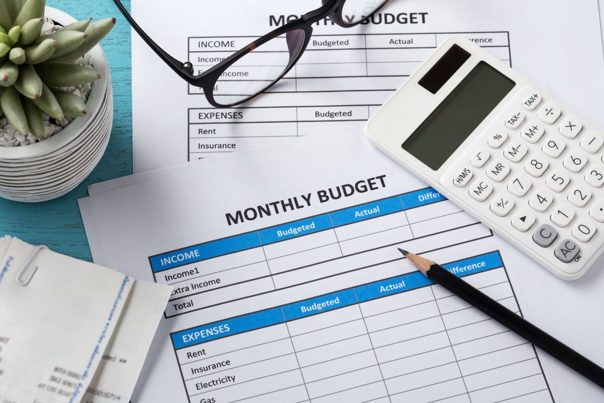 The photo shows monthly budget forms.