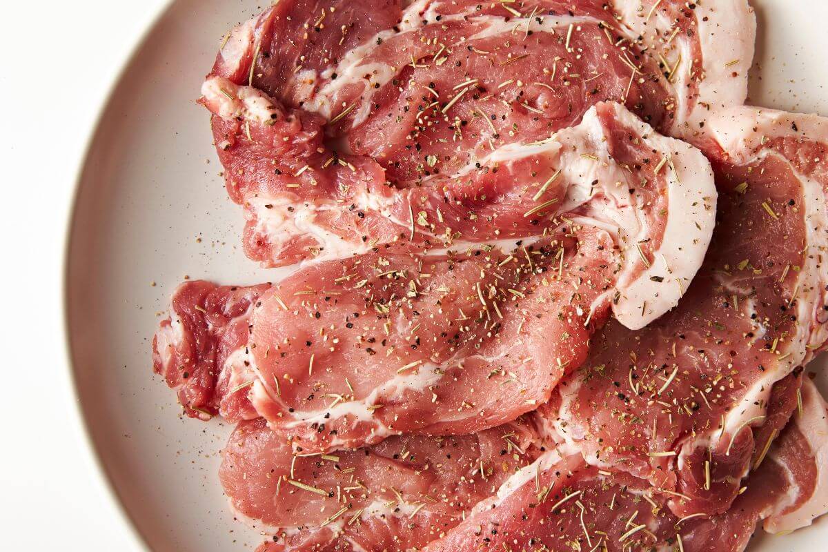 The image tells about seasoned meat on the plate can cost more per pound, buying plain cuts or meat and marinating them at home is much cheaper.