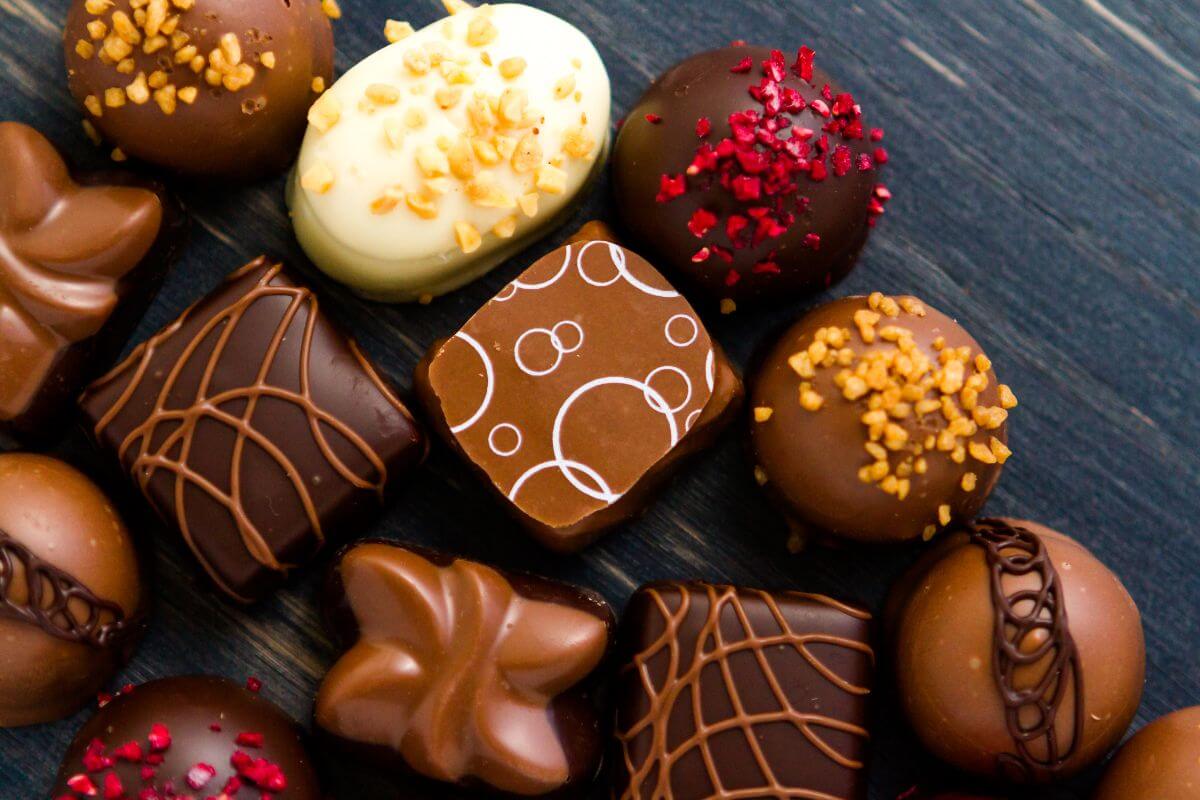 The photo tells about different flavors of chocolates on the table indicating that premium chocolates can cost two or three times more than standard brands, and store-brand can be just as good.