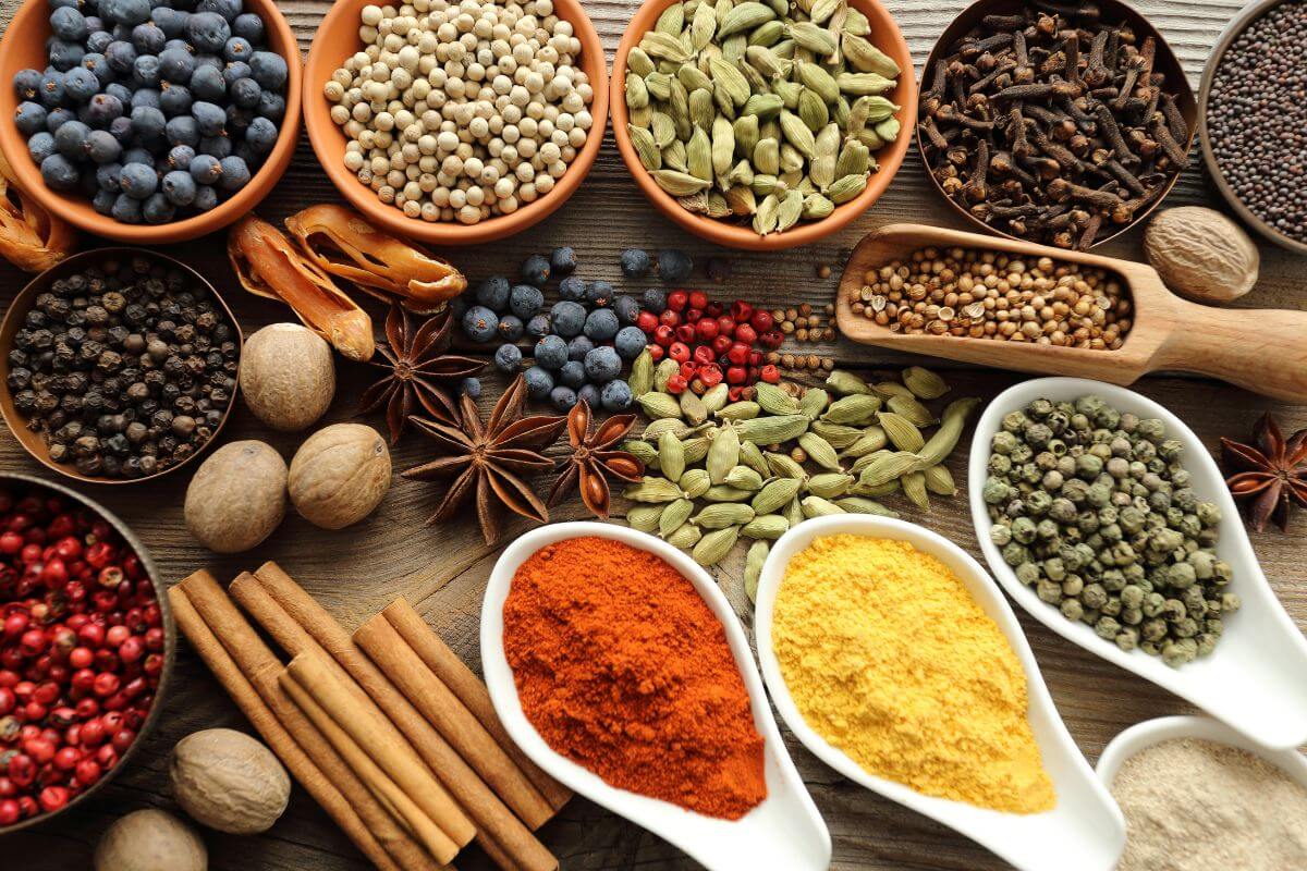 The photo of bows with different types of spices on the table indicates that exotic spices often come with high markups, buying simple spices in bulk is usually cheaper than small jars of name-brand blends.