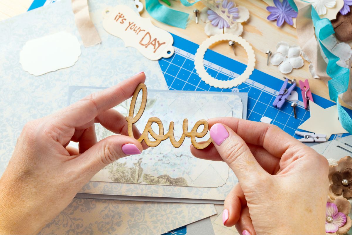 Image of a woman's hand making a scrapbook.