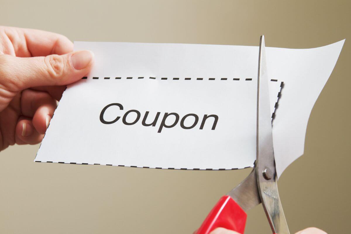 The photo tells about a girl's hand cutting the edges on the paper with a note which means a coupon book with redeemable favors is a fun way to give thoughtful gifts without spending money.