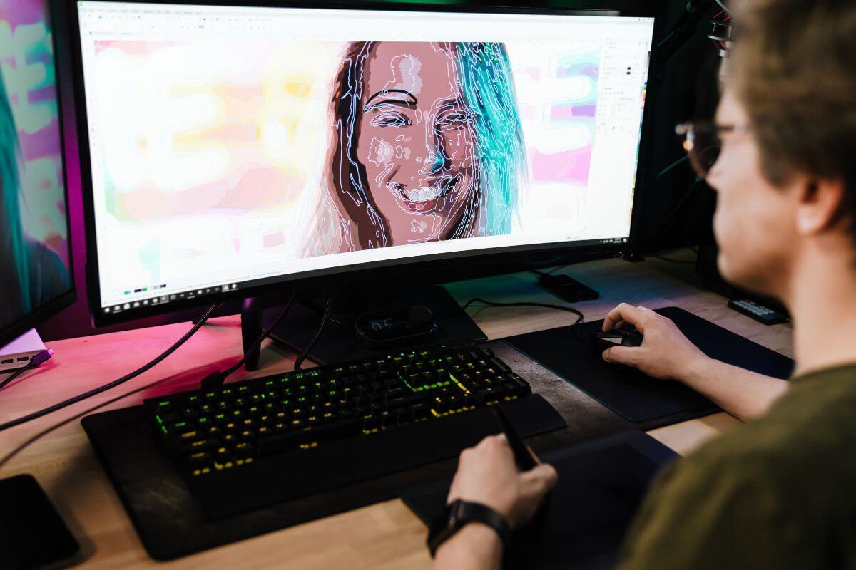The photo shows a man using a computer to edit the raw video of his girlfriend indicating a video montage of shared moments, it's a great way to look back on your relationship and appreciate how far you've come.