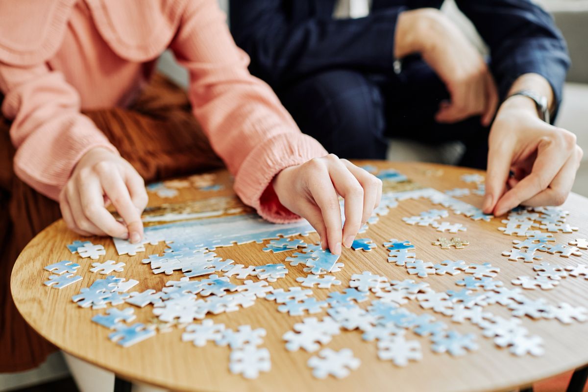 Image of a couple playing puzzled.