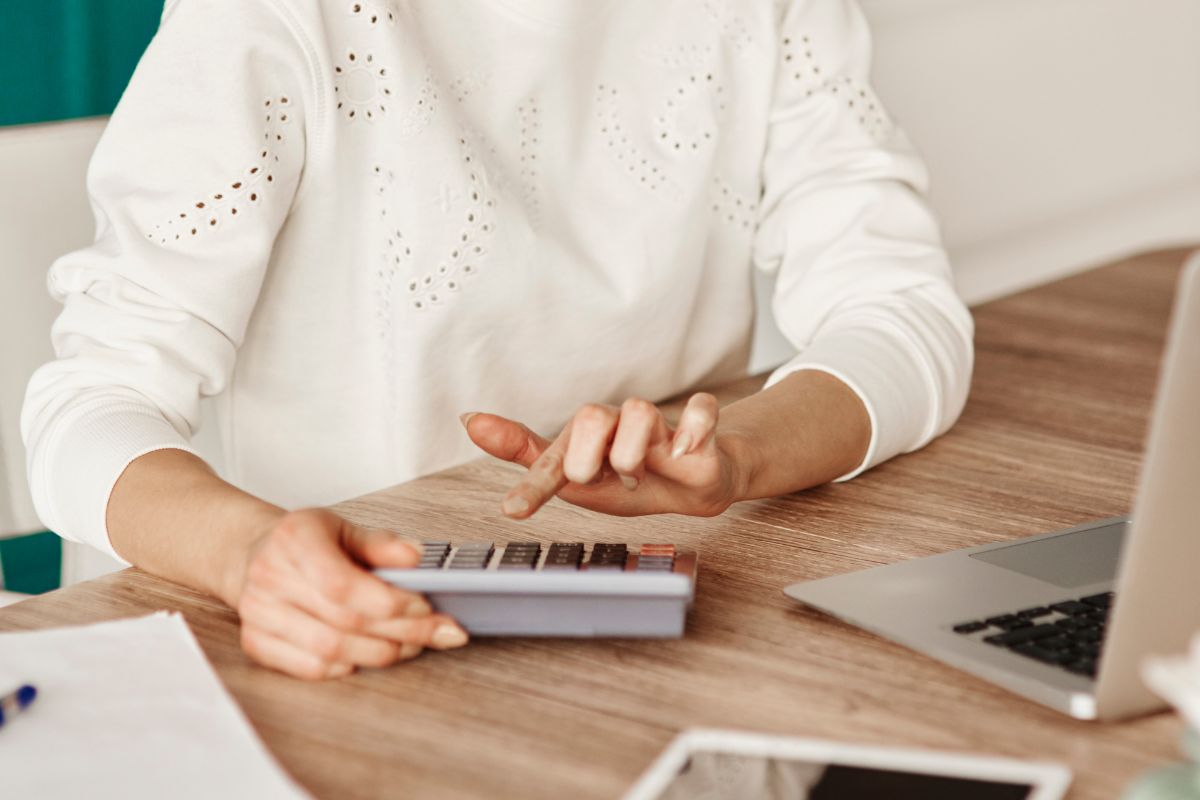 The photo shows a woman budgeting.